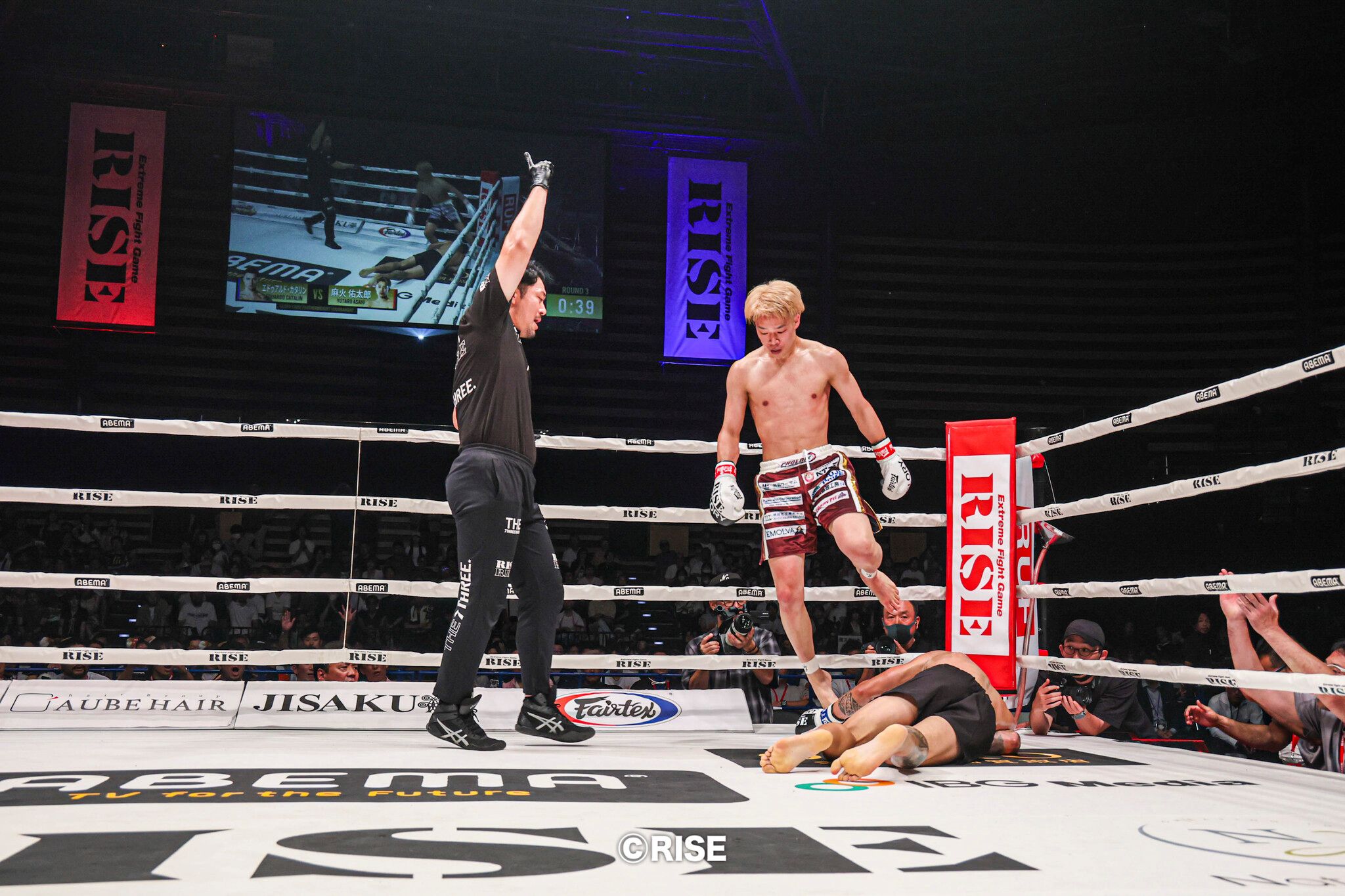 Asahi steps over a knocked out Catalin after a head kick