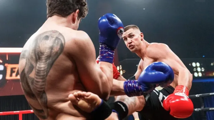 Nikita Kozlov lands a kick.